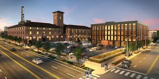 Modern PACE center with parking lot and vibrant urban surroundings at sunset.