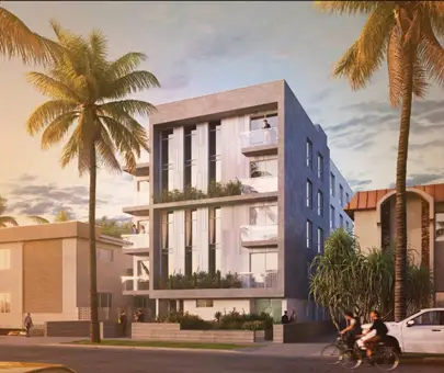 Modern multi-story residential building with balconies and lush greenery in a tropical setting.