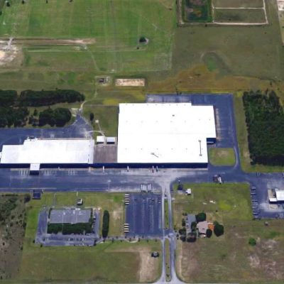 Modern healthcare facility at Bayview PACE with large parking and surrounding green space.