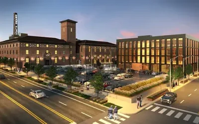 Modern PACE center with parking lot and vibrant urban surroundings at sunset.