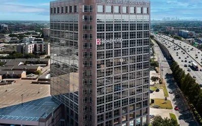 Modern office building with Walters Balido & Crain and Bradford logos in a cityscape view.